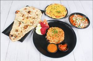 Paneer Tikka Masala + 3 Butter Naan + Veg Biryani + Raita + Green Salad + Masala Papad + Pickle