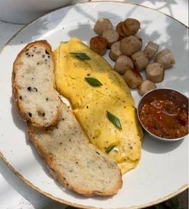 French Omelette With Cheese And Sausages In Garlic Butter