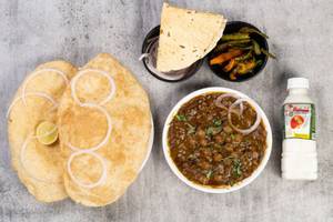 Chole [250ml] + 2 Bhature + Pickle + Salad + Chass + Roasted Papad