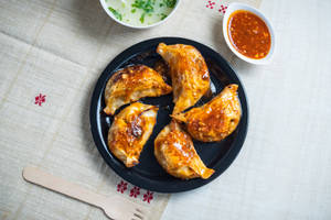 Chicken and cheese momo pan fry in hot garlic sauce