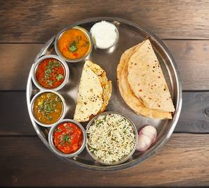 Mini thali   ,4 chapati , jeera rice , 1 sabji panjabi , 1 dal fry , 1regular bhaaji ,  , papad