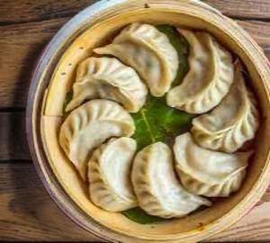 Deluxe Veg Momo Full 10 piece's serve with ketchup and red chilli