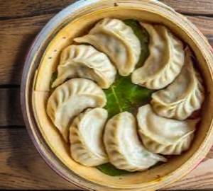 Deluxe Veg Momo Half 6 Piece's serve with ketchup and red chilli