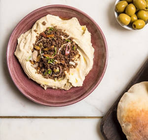 HUMMUS LAHME (Served with our house-made puffed pita)