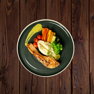Grilled Salmon With Lemon Dill Sauce Served With Tossed Vegetables