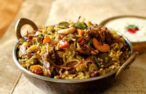 Hyderabadi Dum Biryani With Raita, Pickle & Papad