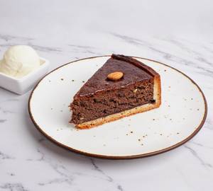 Almond And Chocolate Cake Slice With One Scoop Of Vanilla