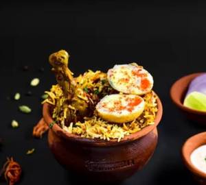 Chicken biryani with egg and raita gravy