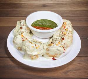 Paneer Momos In Afghani Sauce [Half]