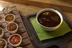 Smoked Pork With Anishi Paste Of Fermented Yam Leaves