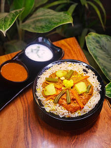 Veg Biryani + raita + gravy 