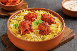 chicken Tikka Biryani Served with Raita and Salad.