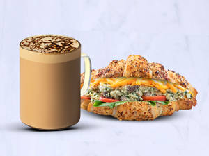 Short Blonde Jaggery Oat Latte with Tofu Spinach Croissant Sandwich