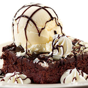 Hot Brownie Topped with Vanilla Ice Cream   Chocolate Sauce 