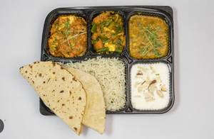 Dal fry + seasonal veg + paneer bhurji + raita + 4 Ghee Tawa Roti + rice + salad + achar 