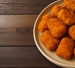 Crispy golden chicken nuggets with a juicy, tender centre, perfect for a delicious snack.