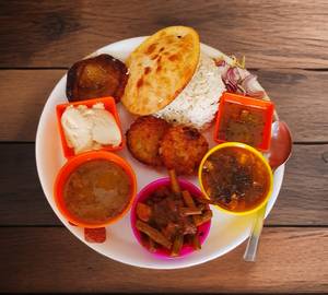 Basmati Rice, Aloo Fry, Dal,  Seasonal Veg Curry, Salad, Pickles, Dahi