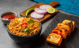 Veg Kadai Masala Rice Served With Paneer Tikka And Salad