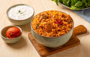 Kodi Pulusu Annam Served With Fried Egg & Raitha