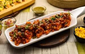 Jain Specials Pan Fried Momos In Schezwan Sauce [6 pieces]
