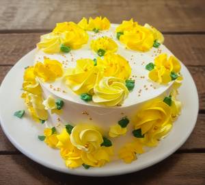 Colourful golden flower white forest cake