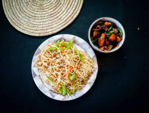 Veg Hakka Noodles with a portion of chicken dry fry