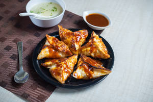 Corn and cheese momo pan fry in bbq sauce