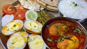 Jumbo egg thali( rice dal sukhi sabzi egg curry paratha desert salad papad)