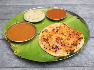 Onion Uttapam (Served With White Chutney, Laal Chutney And Sambhar)