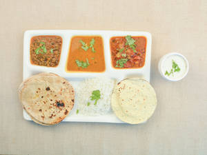 Gujarati thali ( Aloo Rasavala + Mug Masala + Dal + Rice + 4 Butter Roti  + Papad