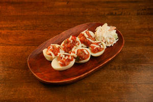 Devilled eggs our way (Boiled egg yolks combined with salsa cheese and jalapeno served on egg whites with cheese.)