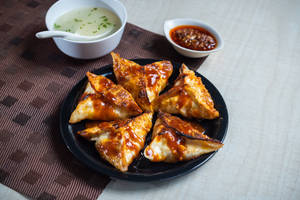 Corn and cheese momo pan fry in schezwan sauce