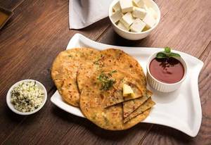 Paneer Paratha Serves With Curd And Pickle