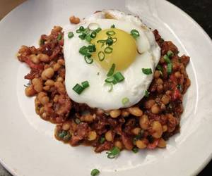 Porky Beans On Toast Topped With A Fried Egg