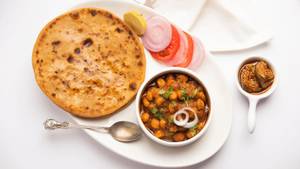 Aloo Garlic Paratha With Chole And Buttermilk