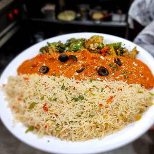 Herbed Rice With Paneer In Paprika Sauce And Sauteed Vegetables