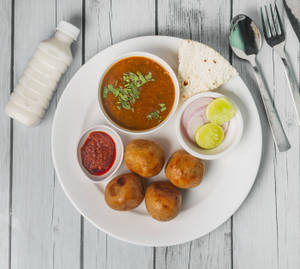 8 Bati, Dal, Lahsun Chatney, Papad, Salad.