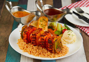 Grilled Hot Garlic Paneer Served With Stir Fried Brown Rice And Saute Vegetables