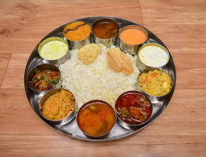 Meal Parcel (Rice + Dal + Curry + Sambar + Rasam + Roti Chutney + Curd + Fry and Friona or Papad) 