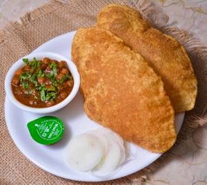 Chole Bhature( 1 Plate Served with sliced onions, Green Chilies, and  Packaged Juice 180ml on the Side)