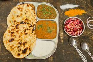 Amritsari Naan Thali (stuffed Potato Naan With Pure Ghee (2 Pcs)+ Dal Makhani + Chole +raita+salad)
