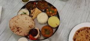 Special Thali ( Dal Fry, 2 Sabzi, Matar Paneer, Raita, Rice Paratha 2 Pcs, Achar, Salad, 1 Sweet Dish.)