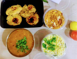 Butter Tadka Dal(500Ml)+ Masala Bati(4Pieces)+Salad+Tradditional Churma (100 Grams)+Jeera Rice (200 Ml)