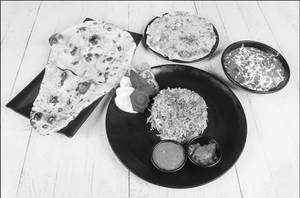 Paneer Tikka Masala + 3 Butter Naan + Veg Biryani + Raita + Green Salad + Masala Papad + Pickle