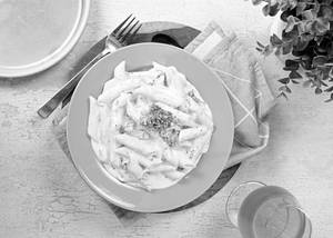 Penne Pasta Tossed With Sun Dried Tomatoes Broccoli and Garlic Cream