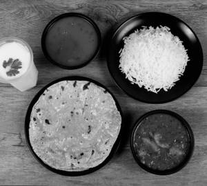 Lasaniya Bataka [250 ml] + Ghee Rotli [3 Pc] + Gujarati Dal Rice [1 Plate] + Buttemilk