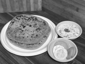 Paneer Paratha With Raitha And Pickle