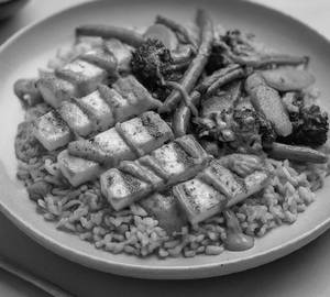 Grilled Hot Garlic Paneer Served With Stir Fried Brown Rice And Saute Vegetables