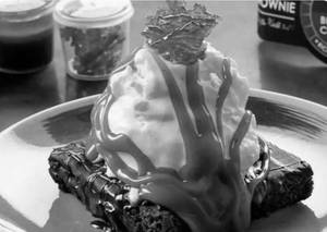 Salted caramel brownie with vanilla ice cream sundae and nuts