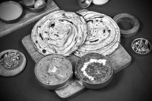 Dal Makhnai [175ml] + Paneer Butter Masala [175ml] + 2 Laccha Paratha